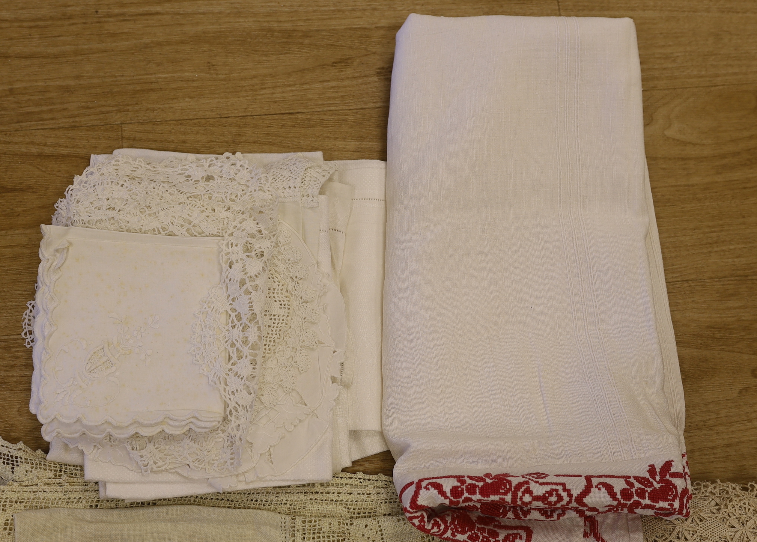 An Edwardian blue embroidered linen table cloth, an Italian embroidered and fillet insertion cloth and various mixed linens